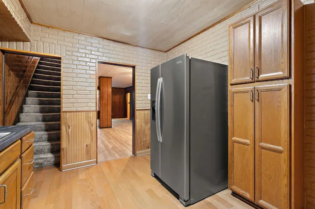 a view of a hallway with wooden cabinets