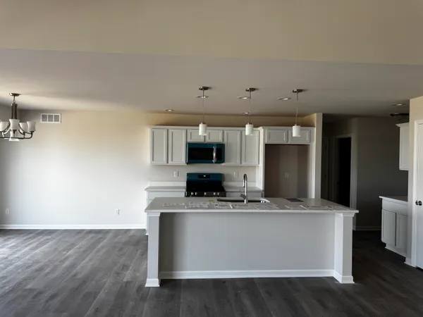 a view living room with stainless steel appliances kitchen island sink and living room view
