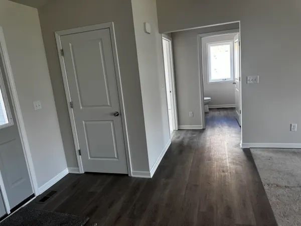 a view of a hallway with wooden floor