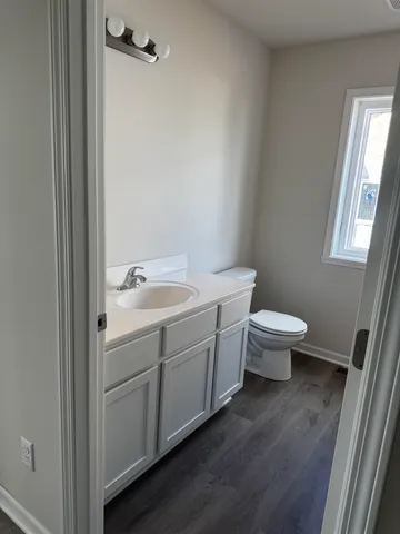 a bathroom with a toilet sink and mirror