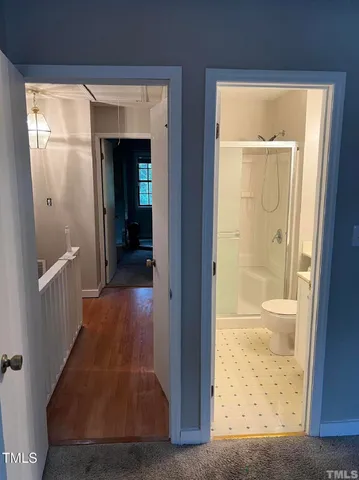 hallway with wooden floor and front door