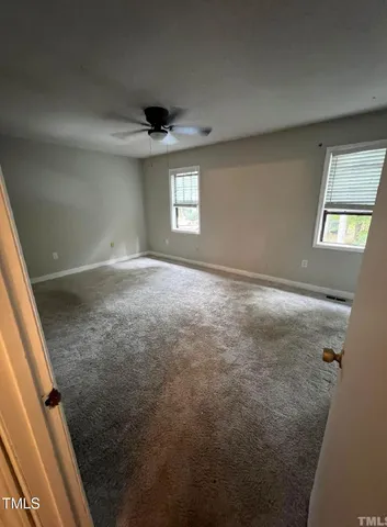 en empty room with windows and entrance