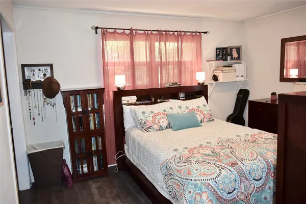 a bedroom with furniture and a window