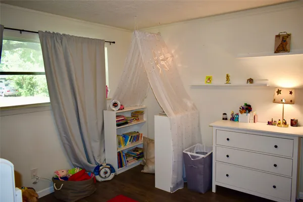 a view of a workspace with furniture and wooden floor