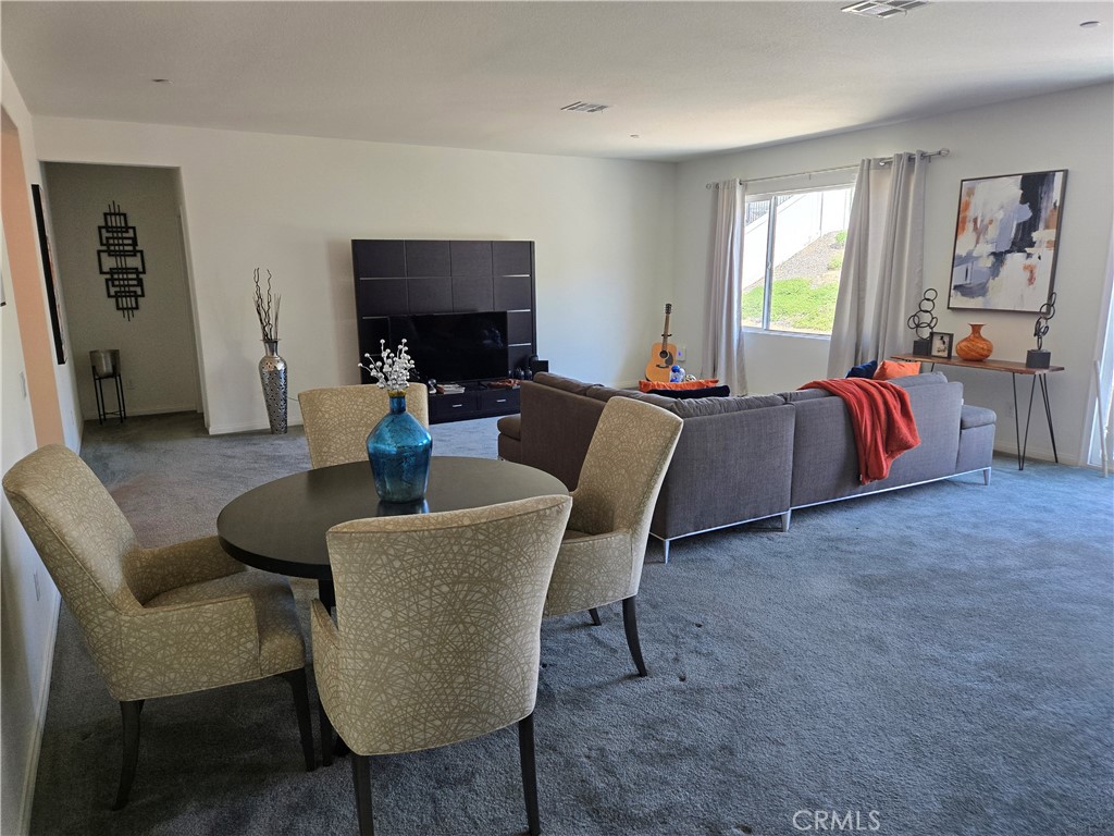 7900 Raincross Court Riverside, CA 92507 - Photo 13 of 21 a living room with furniture a large window and a flat screen tv