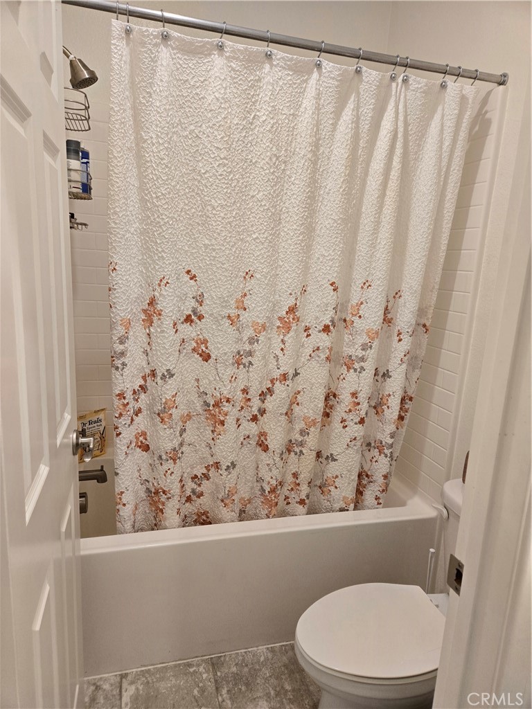 7900 Raincross Court Riverside, CA 92507 - Photo 10 of 21 a bathroom with a toilet and a shower curtain