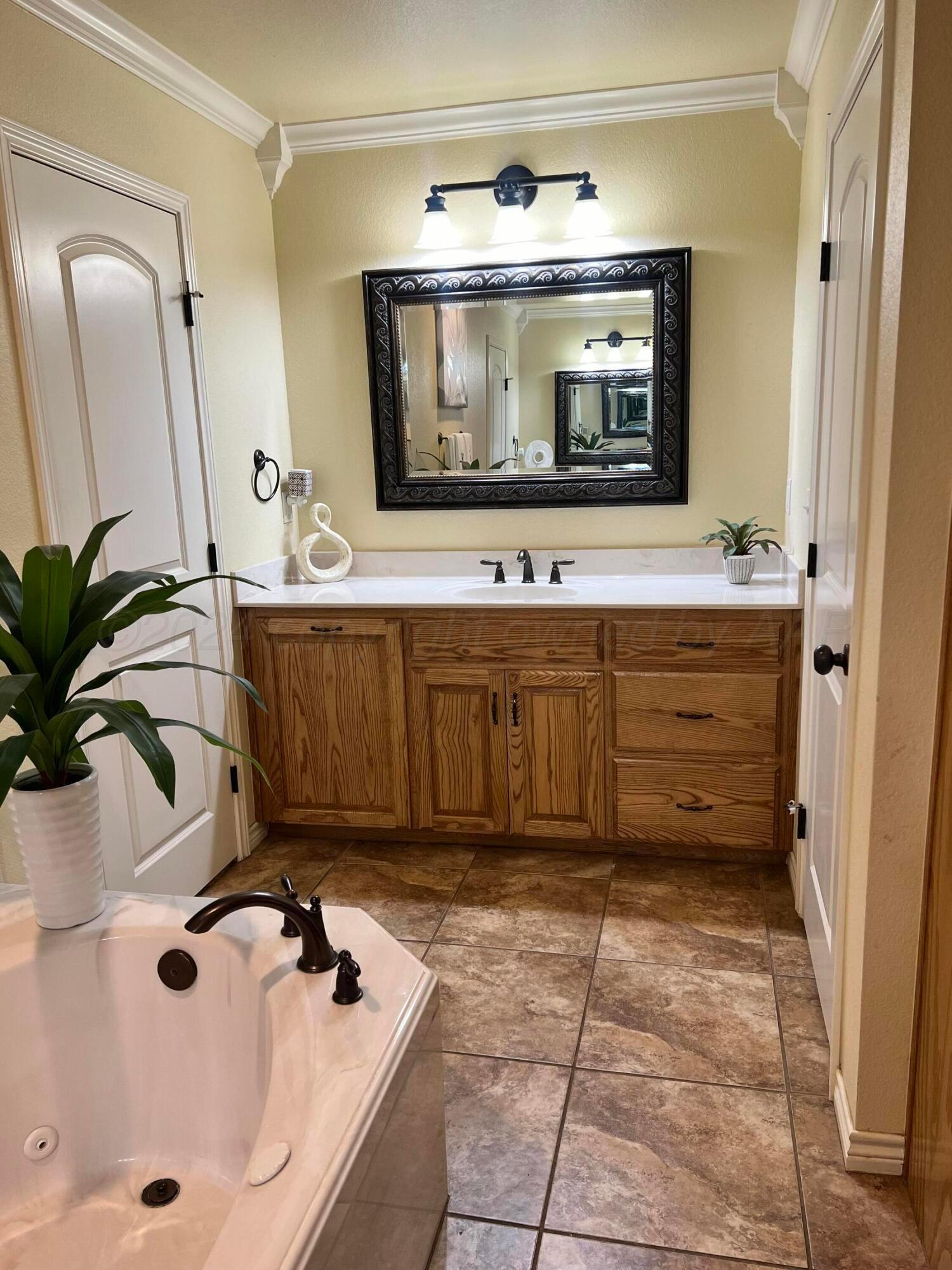 830 Baltimore Drive Hereford, TX 79045 - Photo 29 of 46 a bathroom with a tub sink and mirror
