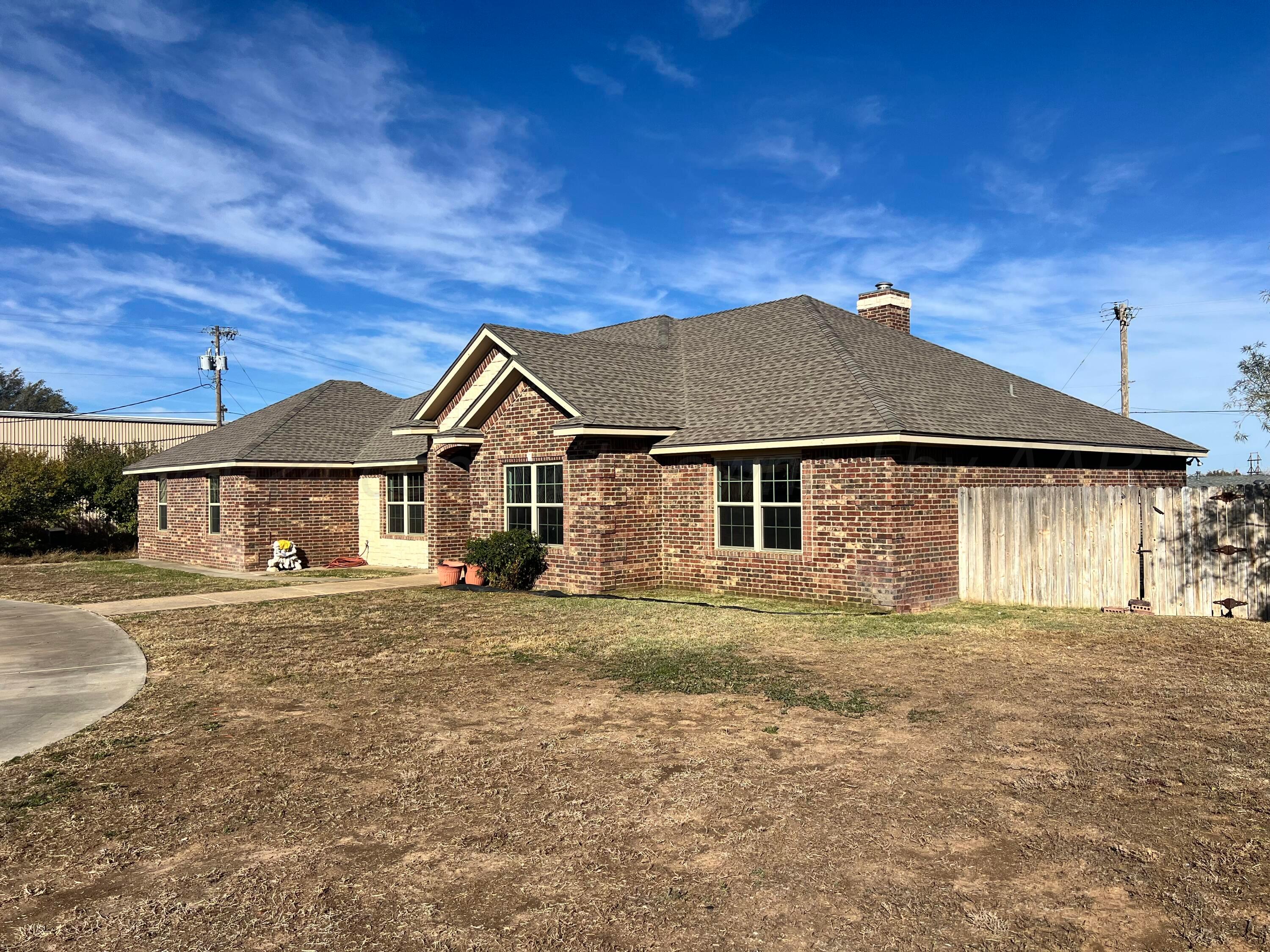 830 Baltimore Drive Hereford, TX 79045 - Photo 3 of 46 a front view of a house with a yard and garage
