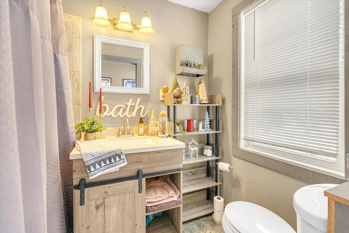 21626 Oak Grove Road Harvard, IL 60033 - Photo 15 of 34 a bathroom with a sink a toilet and a window