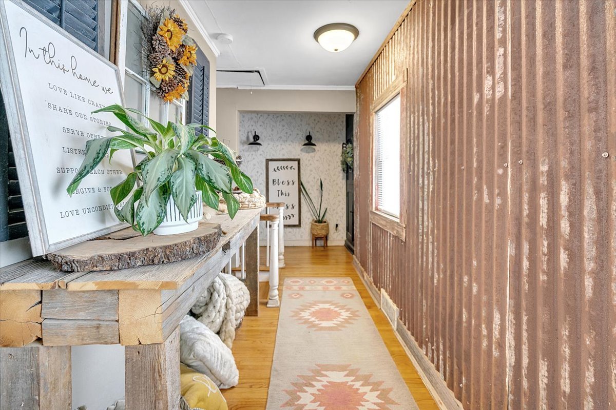 21626 Oak Grove Road Harvard, IL 60033 - Photo 19 of 34 a hallway with painting on the wall and a potted plant