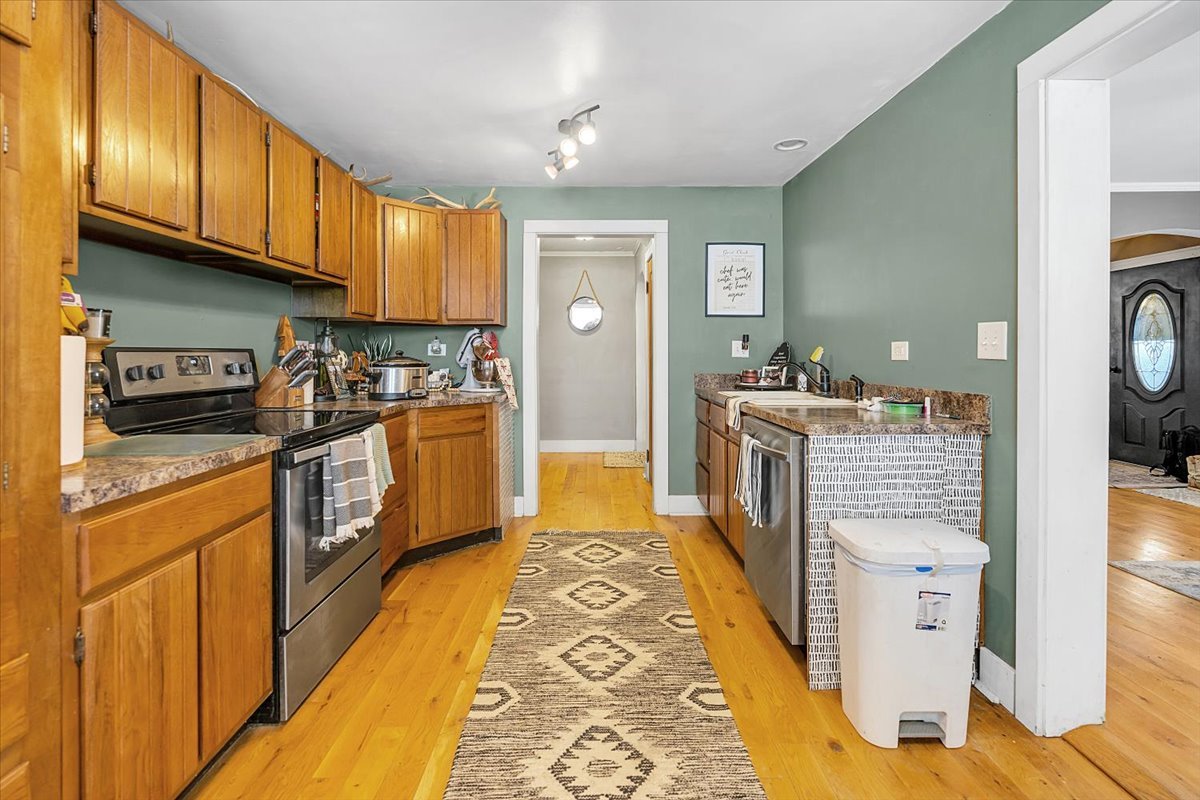 21626 Oak Grove Road Harvard, IL 60033 - Photo 6 of 34 a kitchen with cabinets and wooden floor