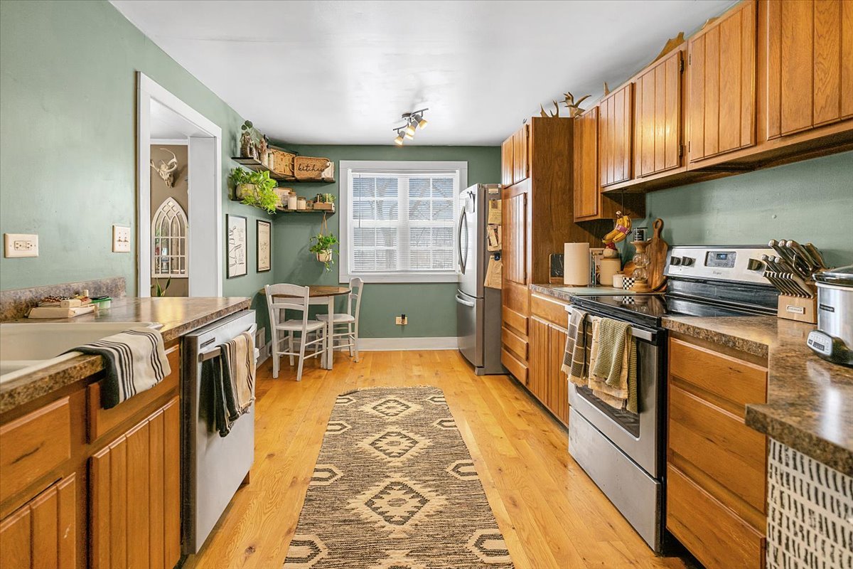 21626 Oak Grove Road Harvard, IL 60033 - Photo 8 of 34 a view of a kitchen with kitchen island granite countertop a large window and stainless steel appliances