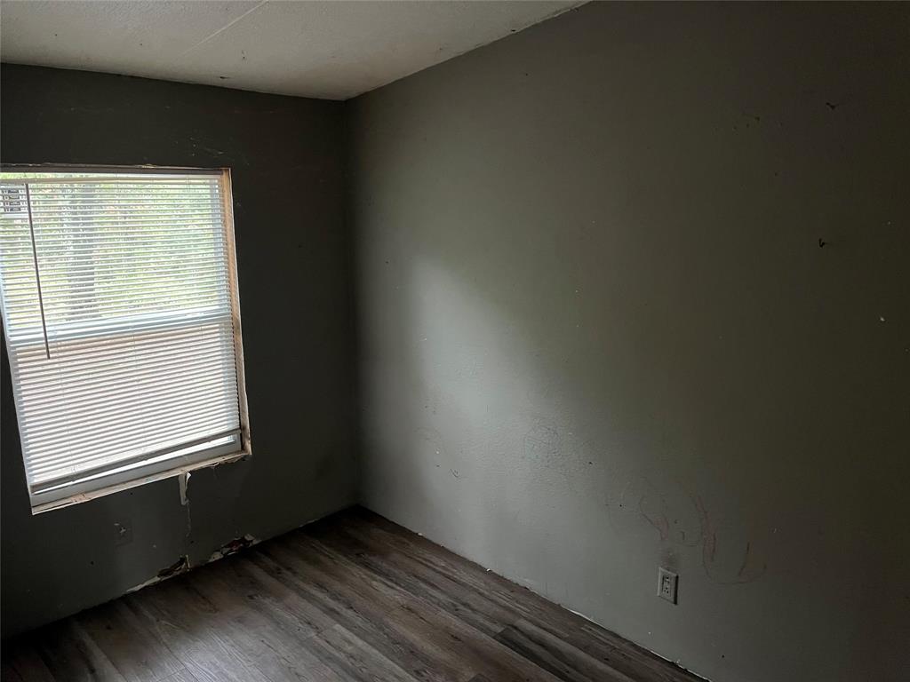 9948 Richardson Road Athens, TX 75752 - Photo 13 of 24 an empty room with wooden floor and windows