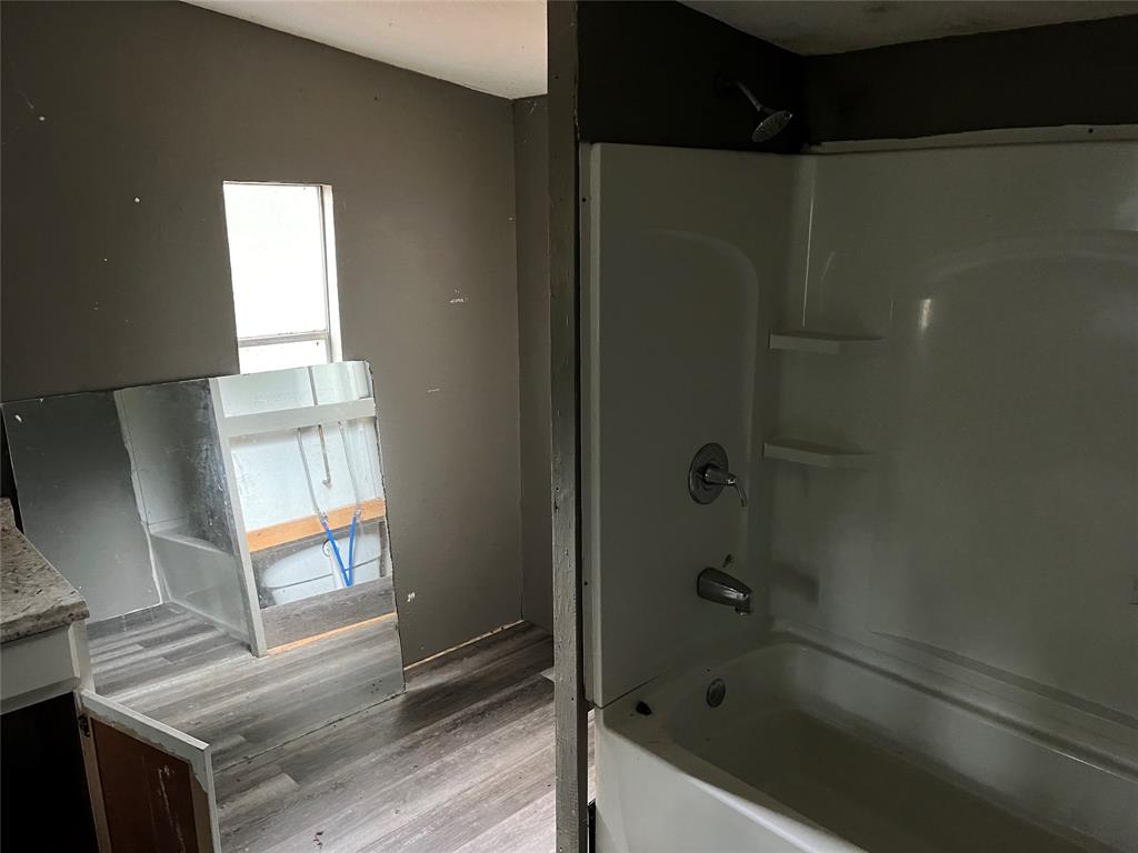 9948 Richardson Road Athens, TX 75752 - Photo 16 of 24 a bathroom with a bathtub and a shower