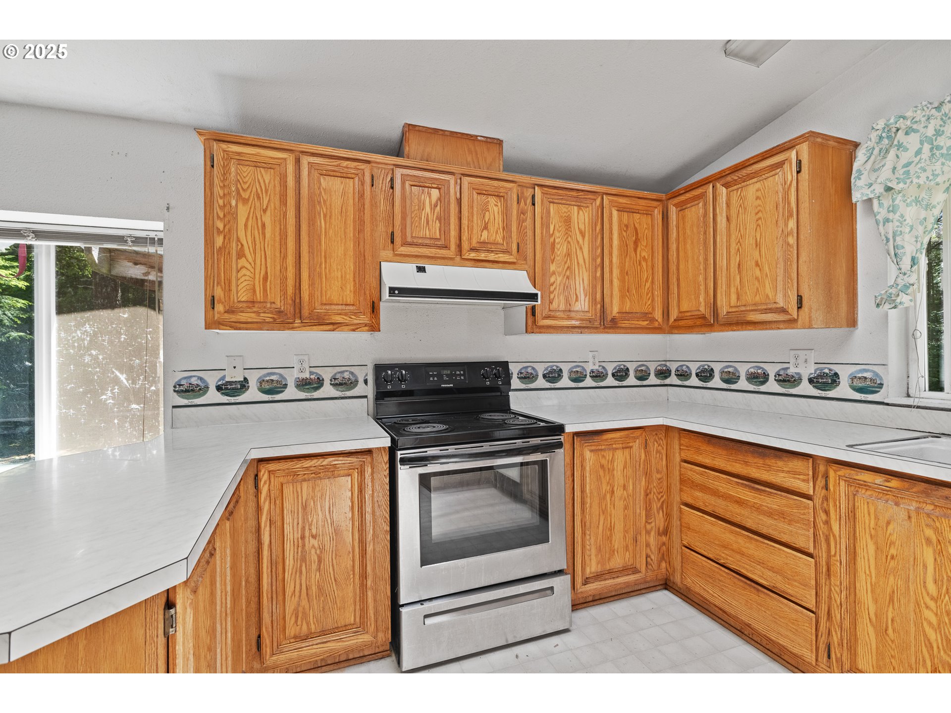 58897 Constance Drive Bandon, OR 97411 - Photo 17 of 37 a kitchen with stainless steel appliances granite countertop a stove a sink and a microwave