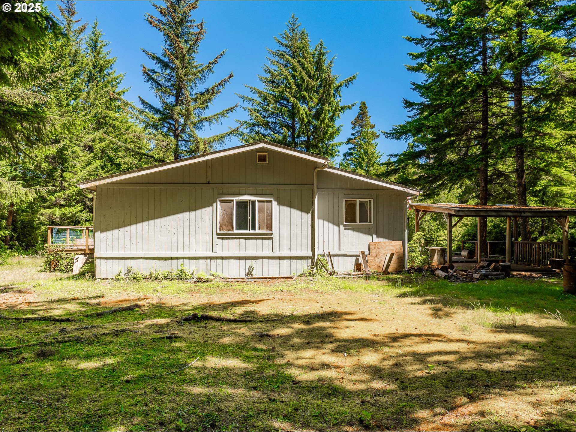 58897 Constance Drive Bandon, OR 97411 - Photo 21 of 37 a big house with a big yard and more trees
