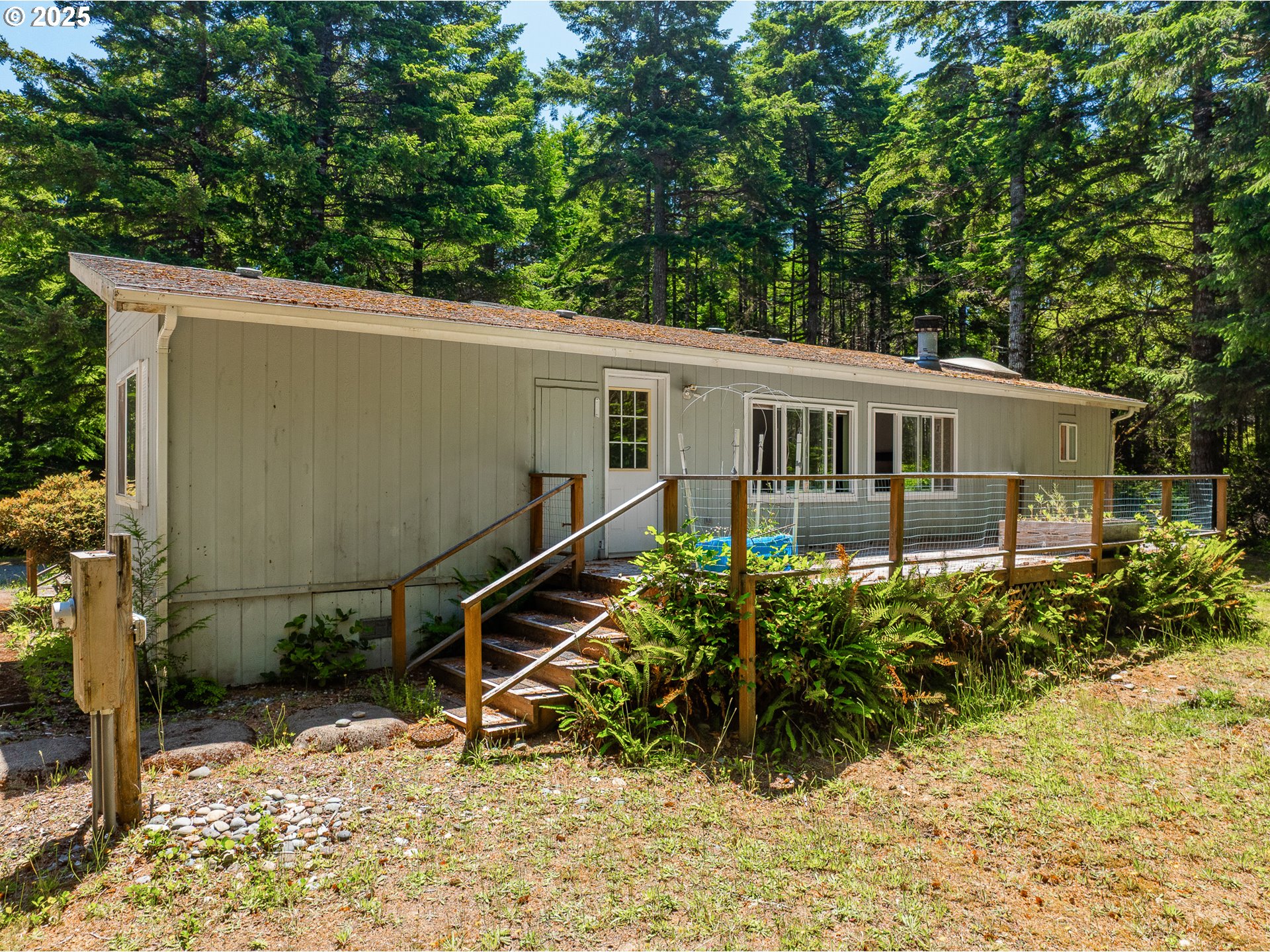 58897 Constance Drive Bandon, OR 97411 - Photo 24 of 37 a view of a house with a backyard