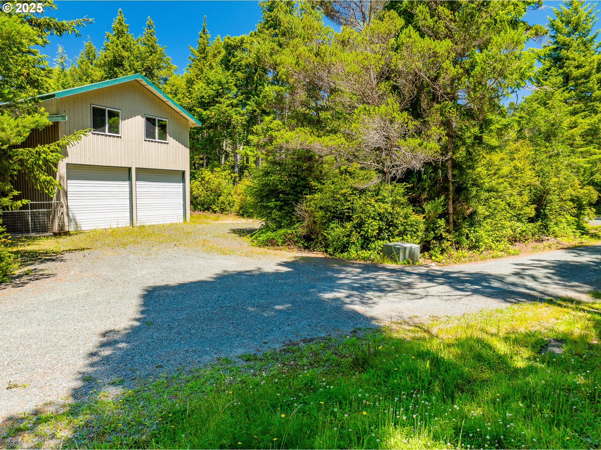 58897 Constance Drive Bandon, OR 97411 - Photo 30 of 37 a front view of a house with a yard and garage