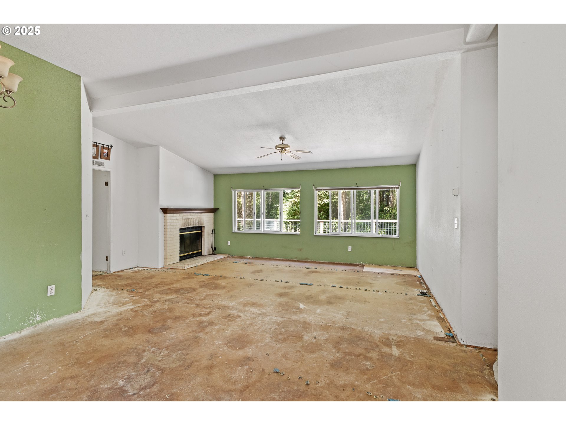 58897 Constance Drive Bandon, OR 97411 - Photo 5 of 37 a view of an empty room with a fireplace and a window