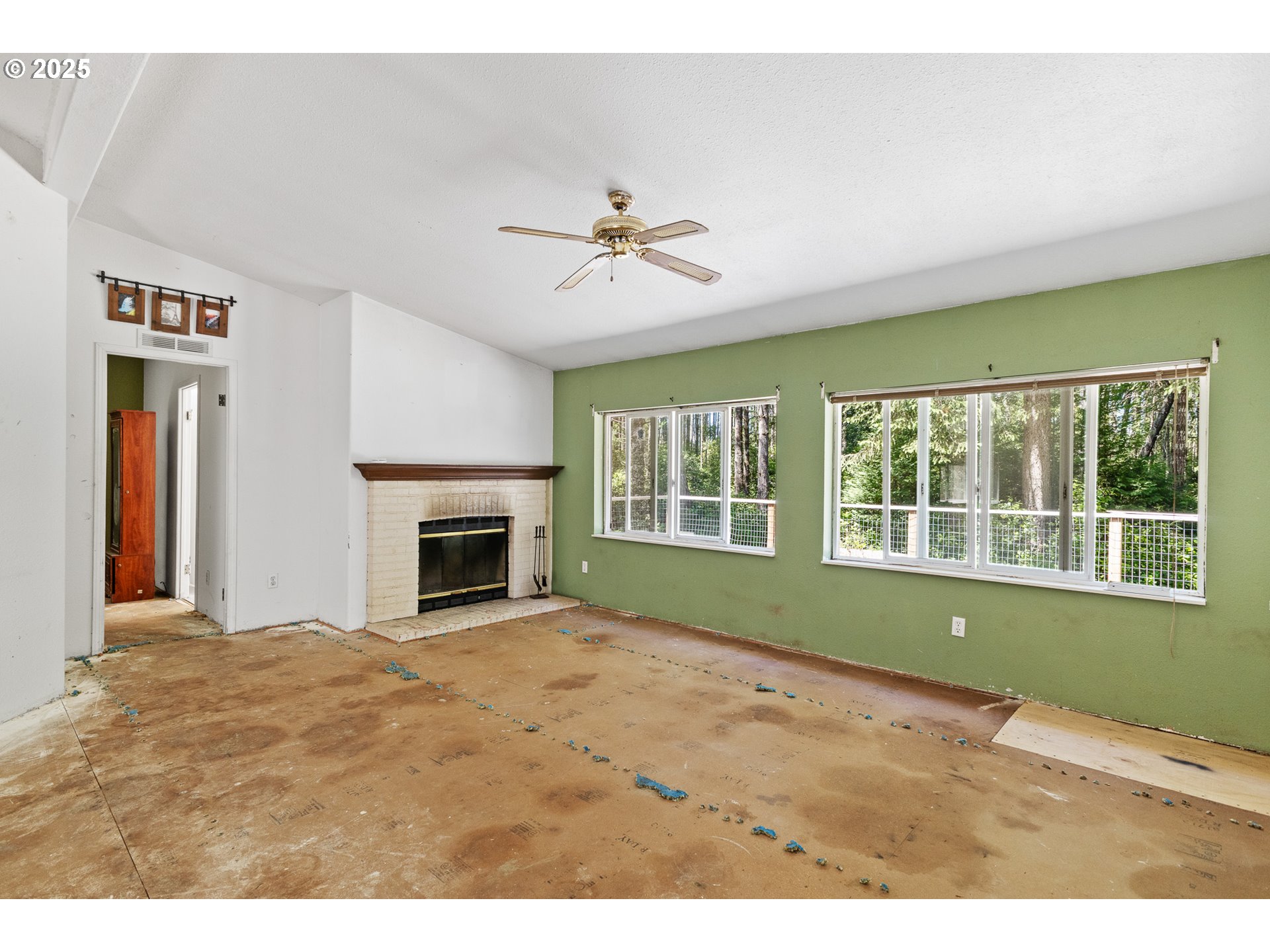 58897 Constance Drive Bandon, OR 97411 - Photo 6 of 37 a view of an empty room with a window and fireplace