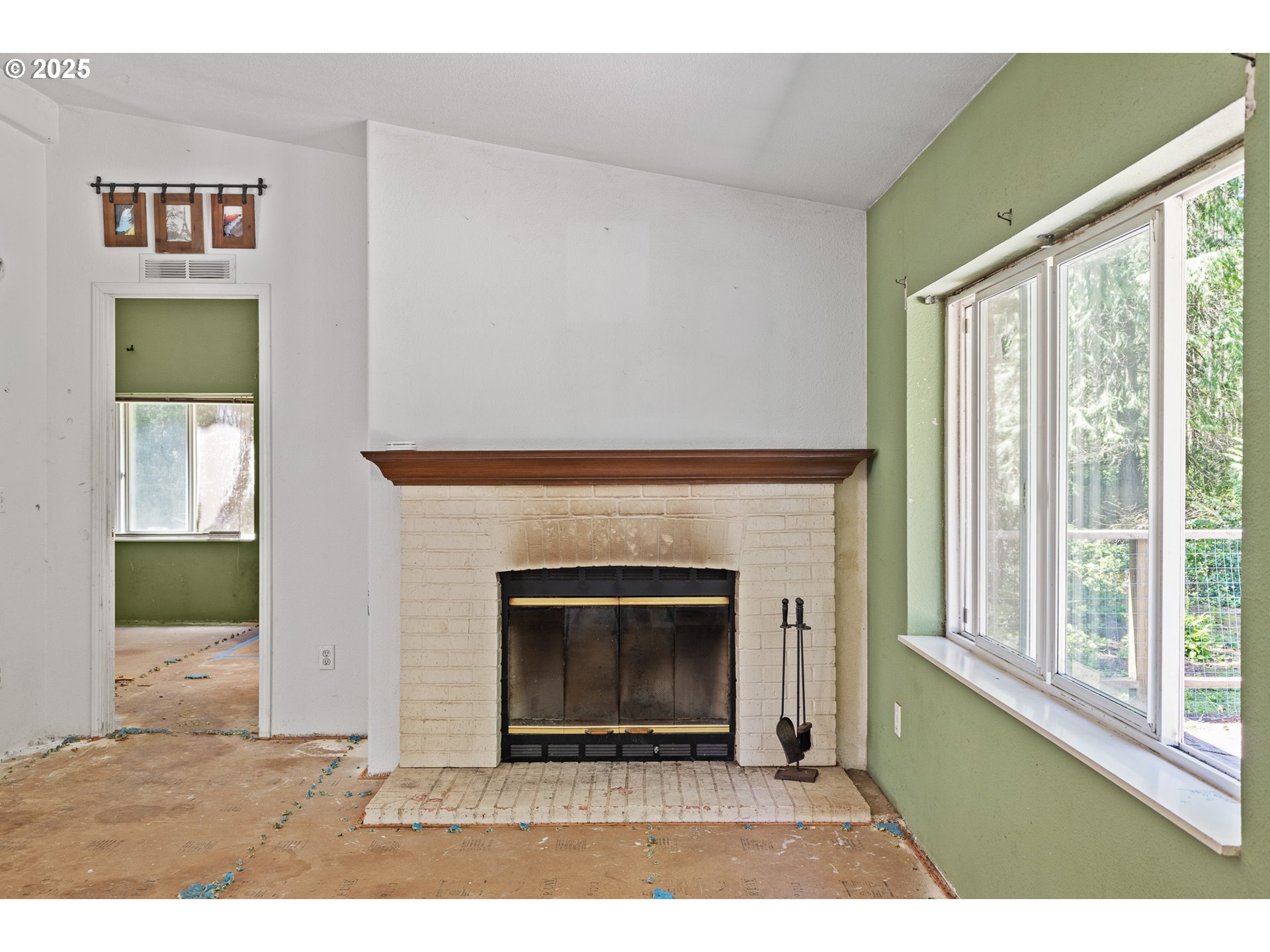 58897 Constance Drive Bandon, OR 97411 - Photo 7 of 37 a living room with a fireplace and a floor to ceiling window