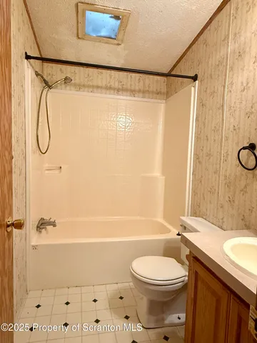 a bathroom with a toilet a sink and shower