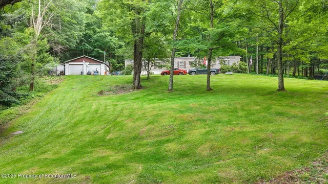 a view of a house with a backyard
