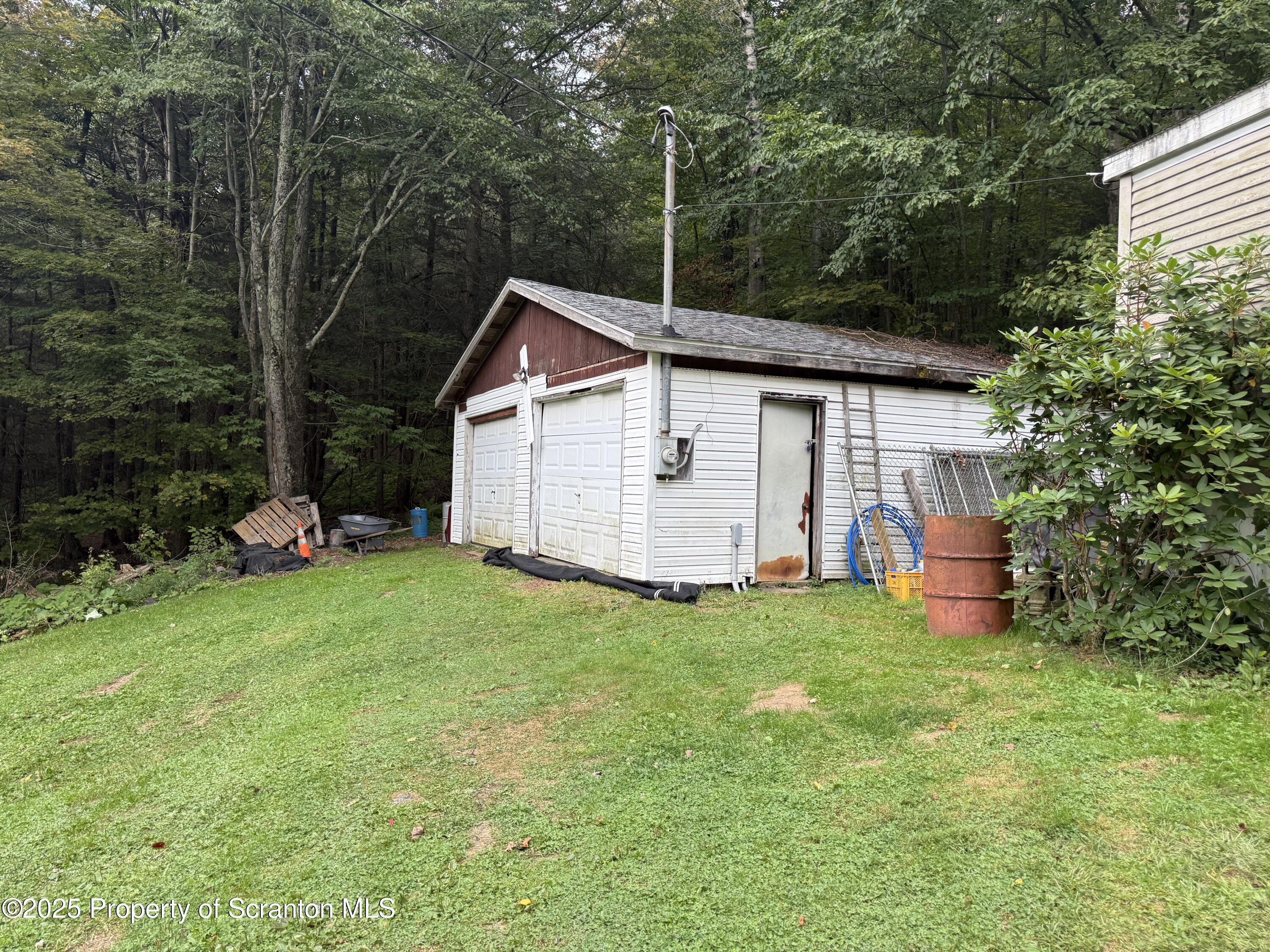 1218 Campsite Road Thompson, PA 18465 - Photo 22 of 26 a view of a backyard with a garden