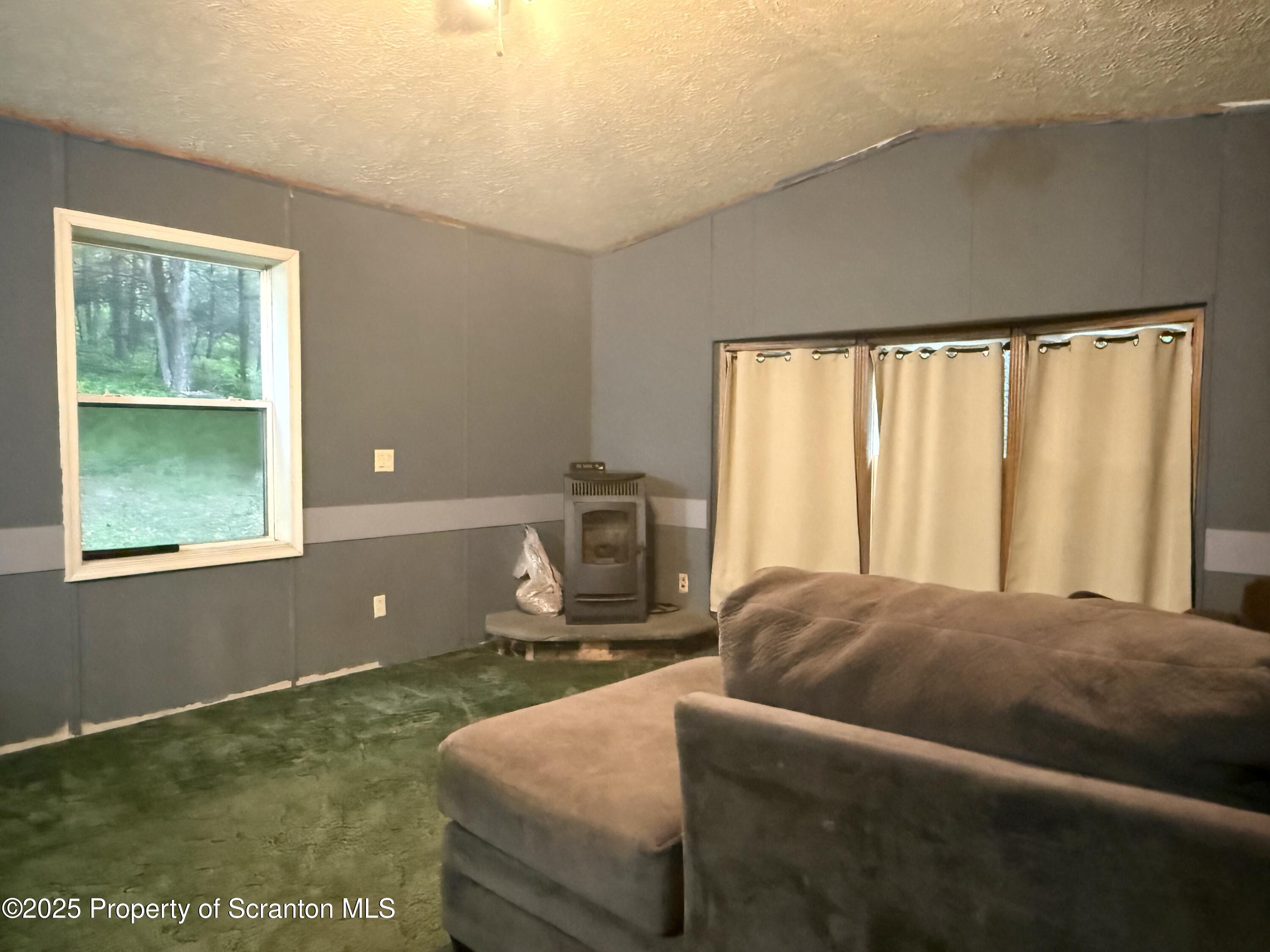 1218 Campsite Road Thompson, PA 18465 - Photo 4 of 26 a bedroom with a bed and a window