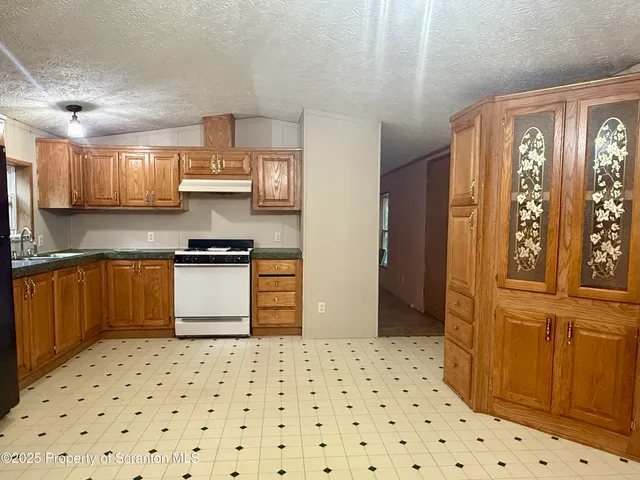 a kitchen with stainless steel appliances a refrigerator and a stove top oven