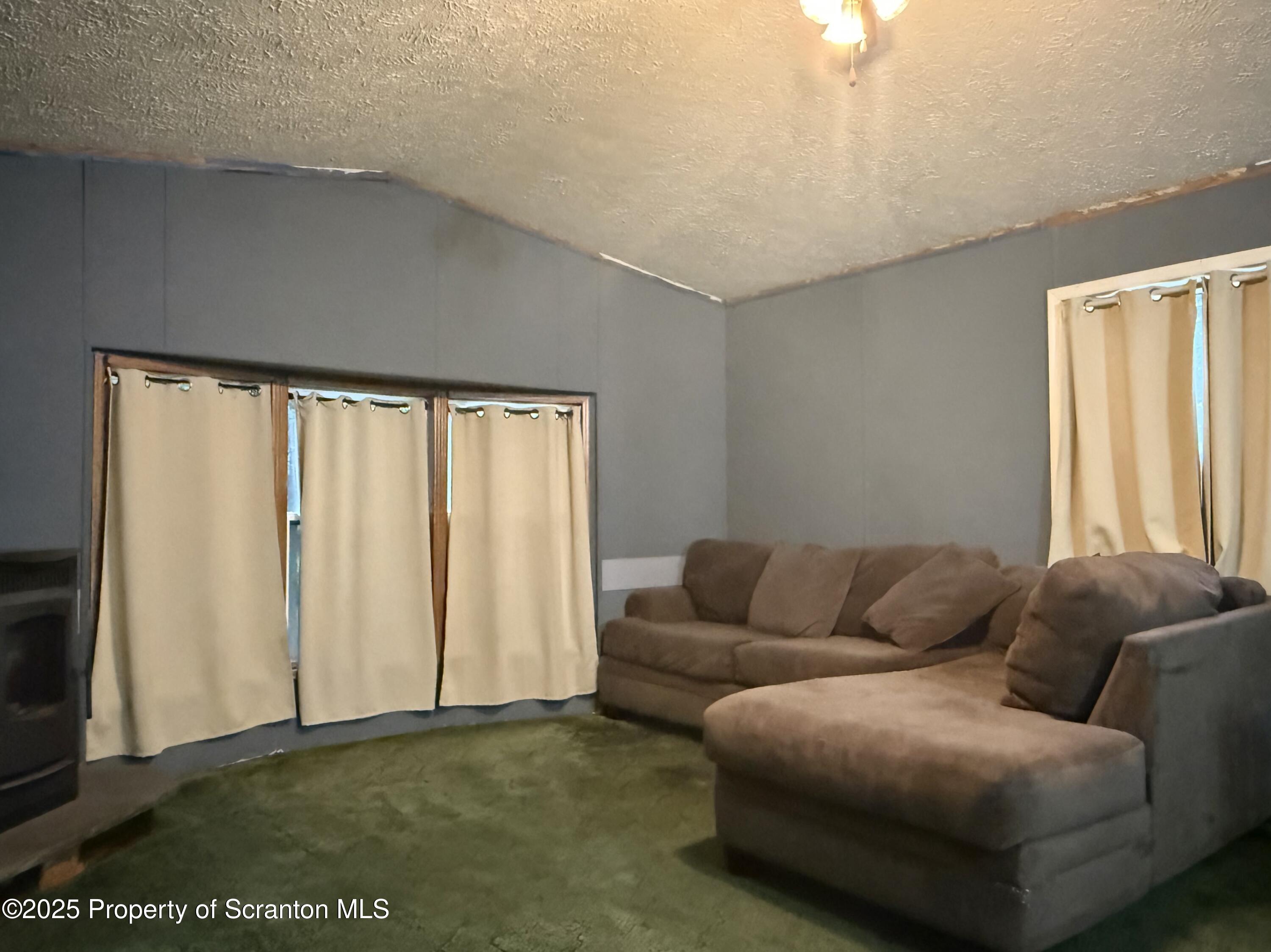 1218 Campsite Road Thompson, PA 18465 - Photo 7 of 26 a living room with furniture and a window