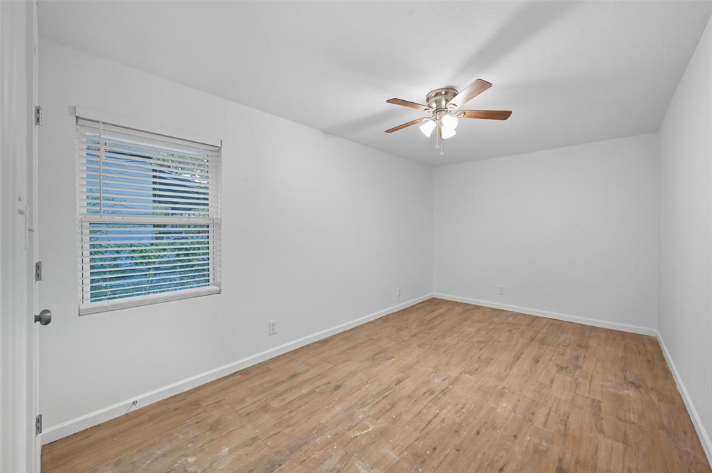809 North Maxey Street Sherman, TX 75090 - Photo 12 of 19 wooden floor in an empty room with a window