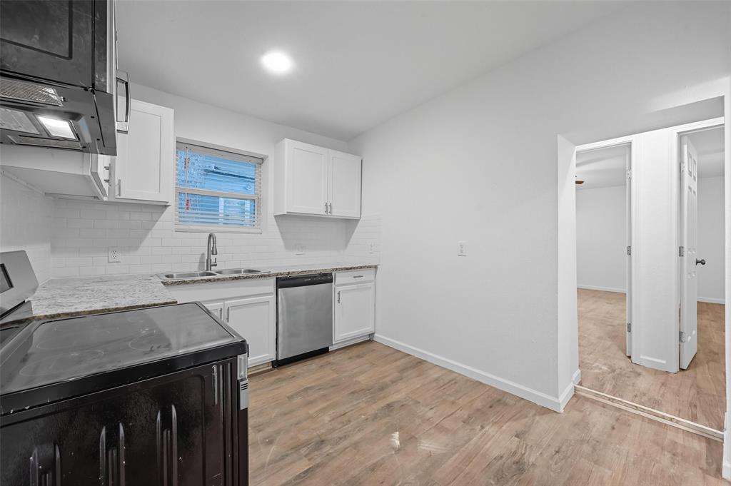 809 North Maxey Street Sherman, TX 75090 - Photo 3 of 19 a kitchen with a sink and a stove top oven