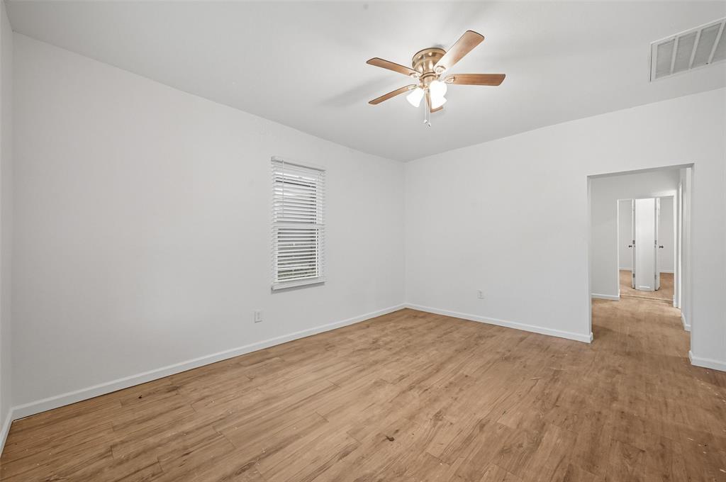 809 North Maxey Street Sherman, TX 75090 - Photo 4 of 19 wooden floor in an empty room with a window