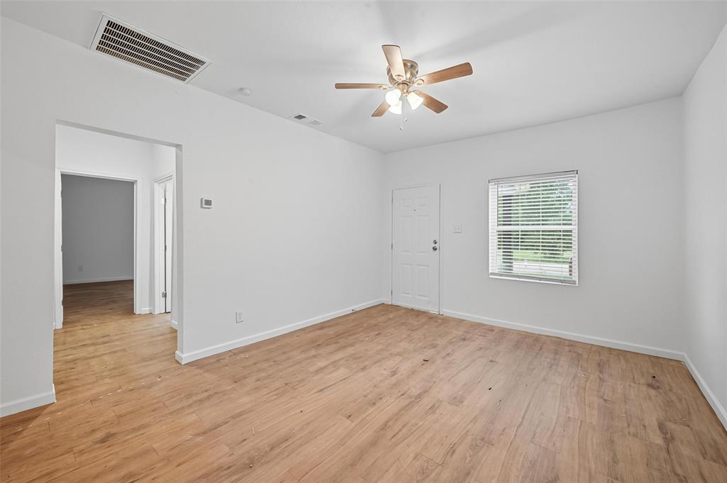 809 North Maxey Street Sherman, TX 75090 - Photo 5 of 19 a view of empty room with wooden floor and fan