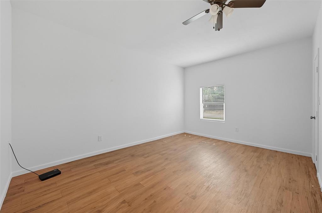 809 North Maxey Street Sherman, TX 75090 - Photo 8 of 19 a view of a room with a wooden floor and white walls