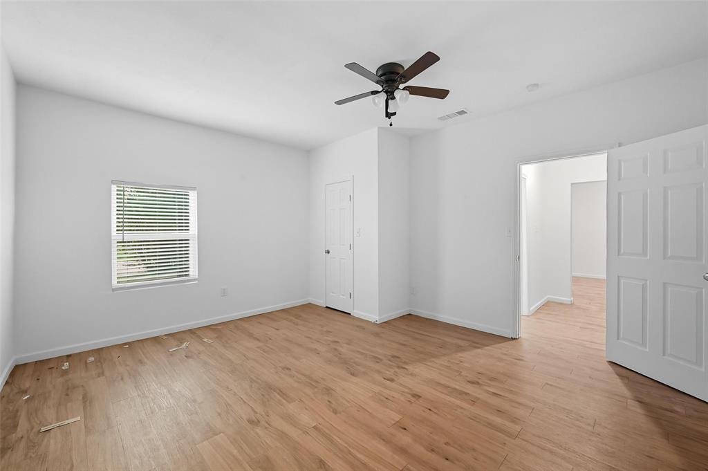 809 North Maxey Street Sherman, TX 75090 - Photo 10 of 19 a view of an empty room with a window and wooden floor