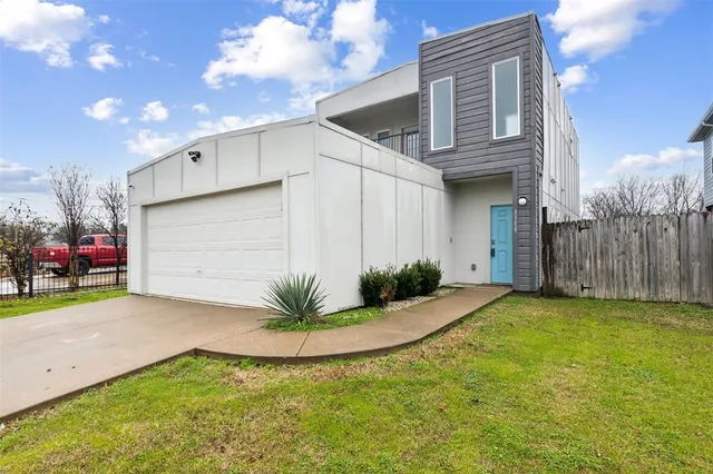 a view of a house with a yard and garage