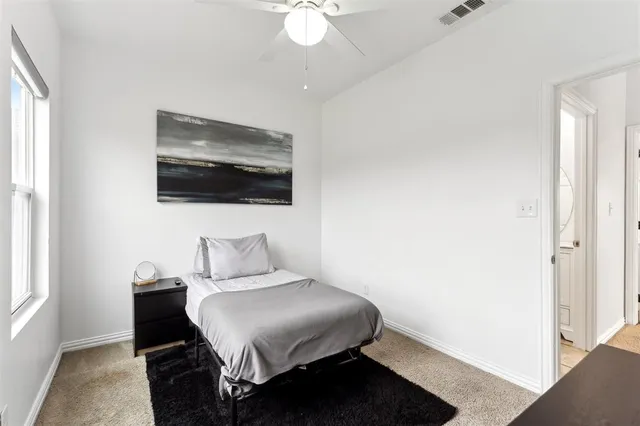 a bedroom with a large bed and a flat screen tv