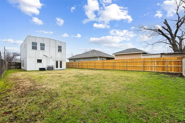 a view of a swimming pool with a patio and a yard