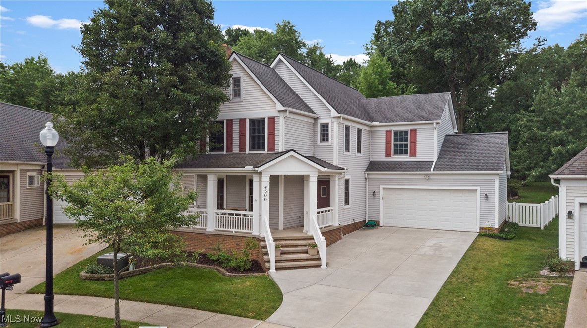 4500 Brooks Road Cleveland, OH 44105 - Photo 1 of 50 View of front of house featuring covered porch, concrete driveway, and a shingled roof