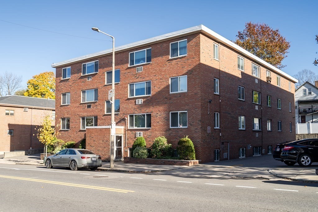 a view of a building and car parked