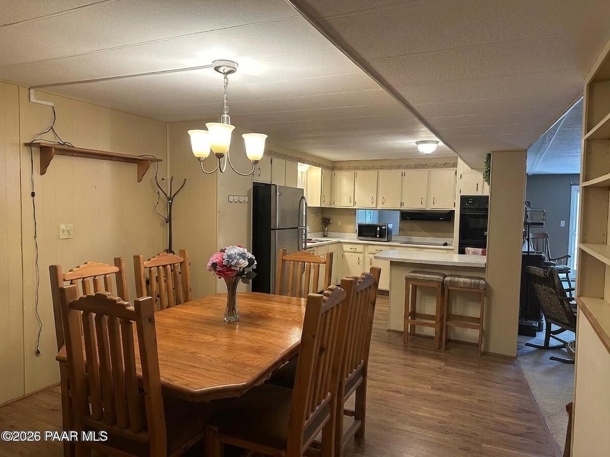 10075 Dapple Grey Trail Dewey, AZ 86327 - Photo 14 of 29 a kitchen with stainless steel appliances kitchen island granite countertop a table chairs and a refrigerator