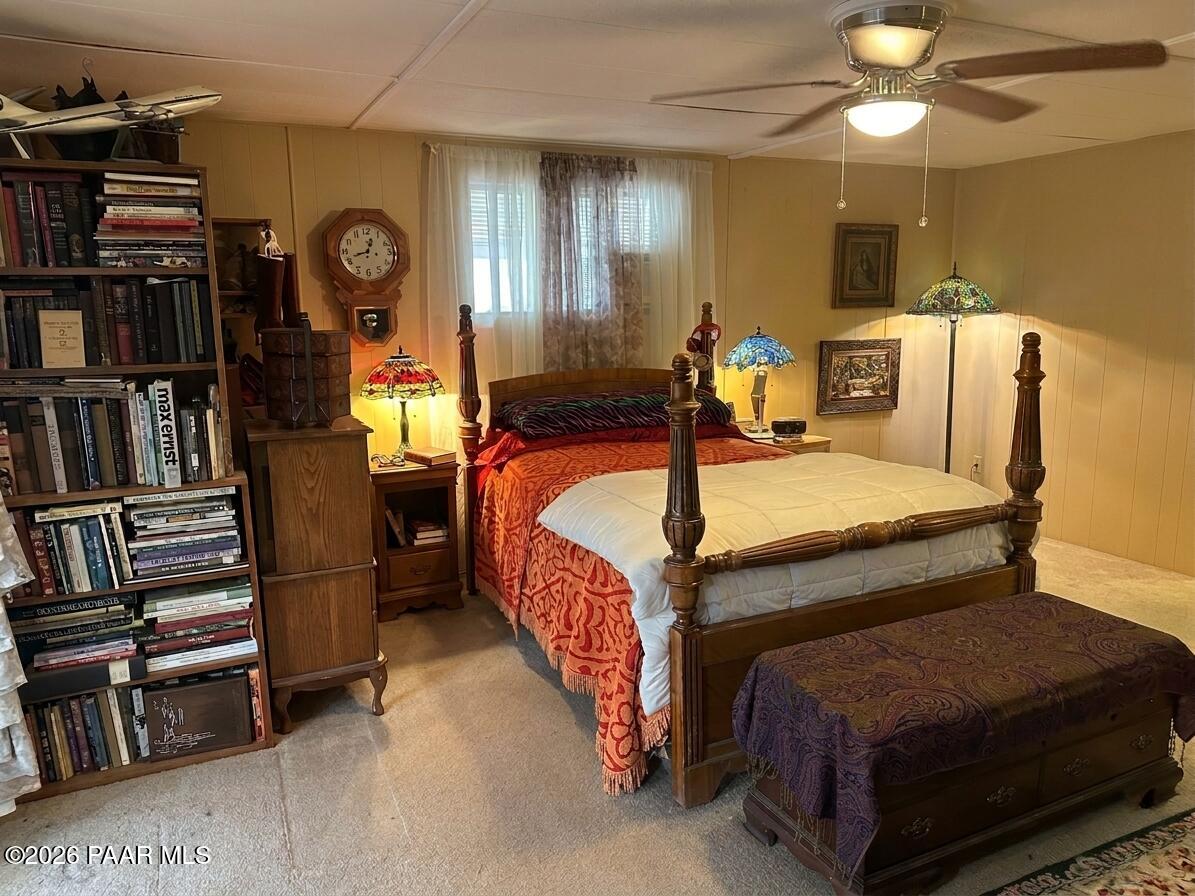 10075 Dapple Grey Trail Dewey, AZ 86327 - Photo 17 of 29 a bedroom with bed and a chandelier