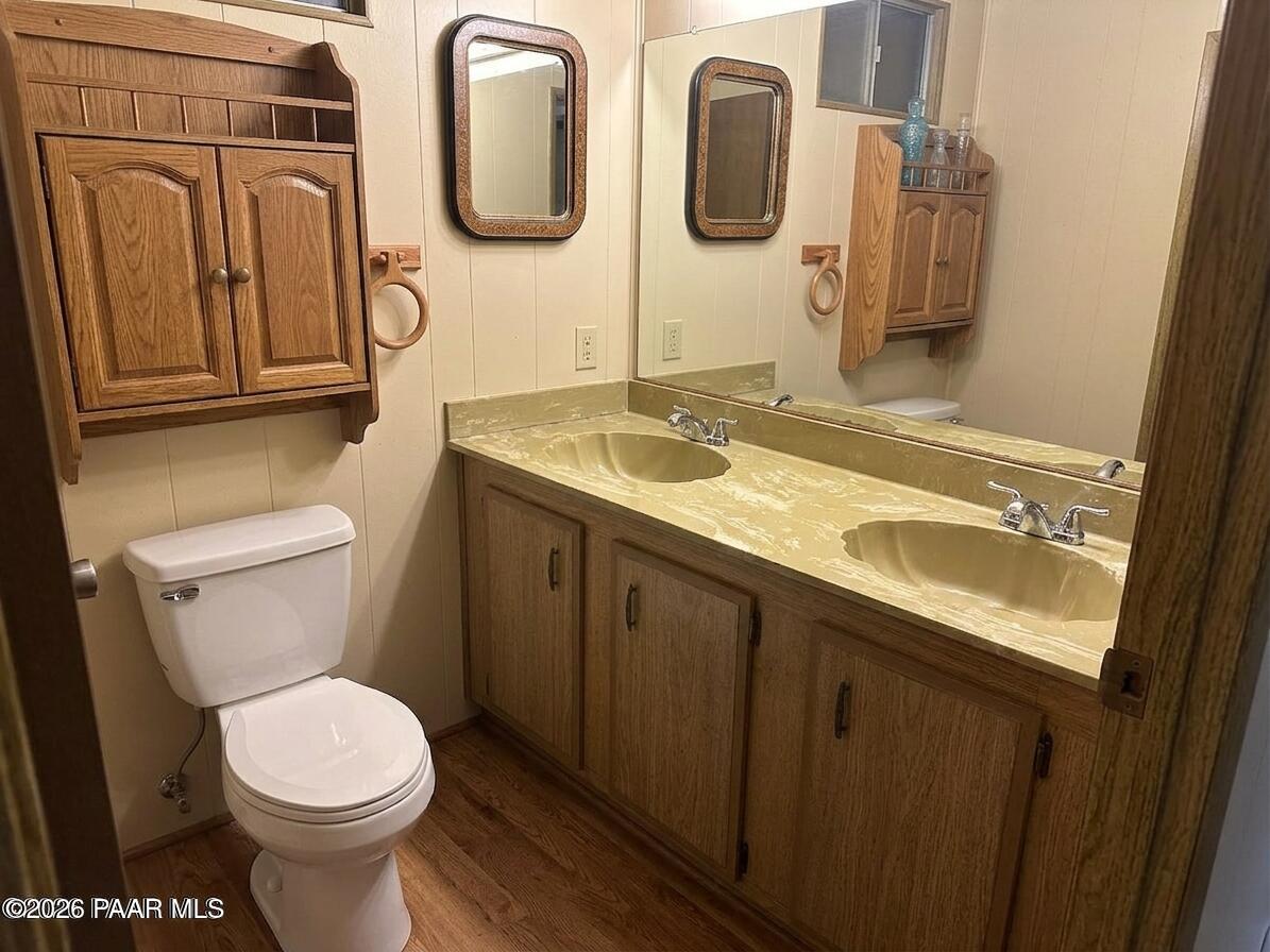 10075 Dapple Grey Trail Dewey, AZ 86327 - Photo 19 of 29 a bathroom with a granite countertop toilet sink and mirror