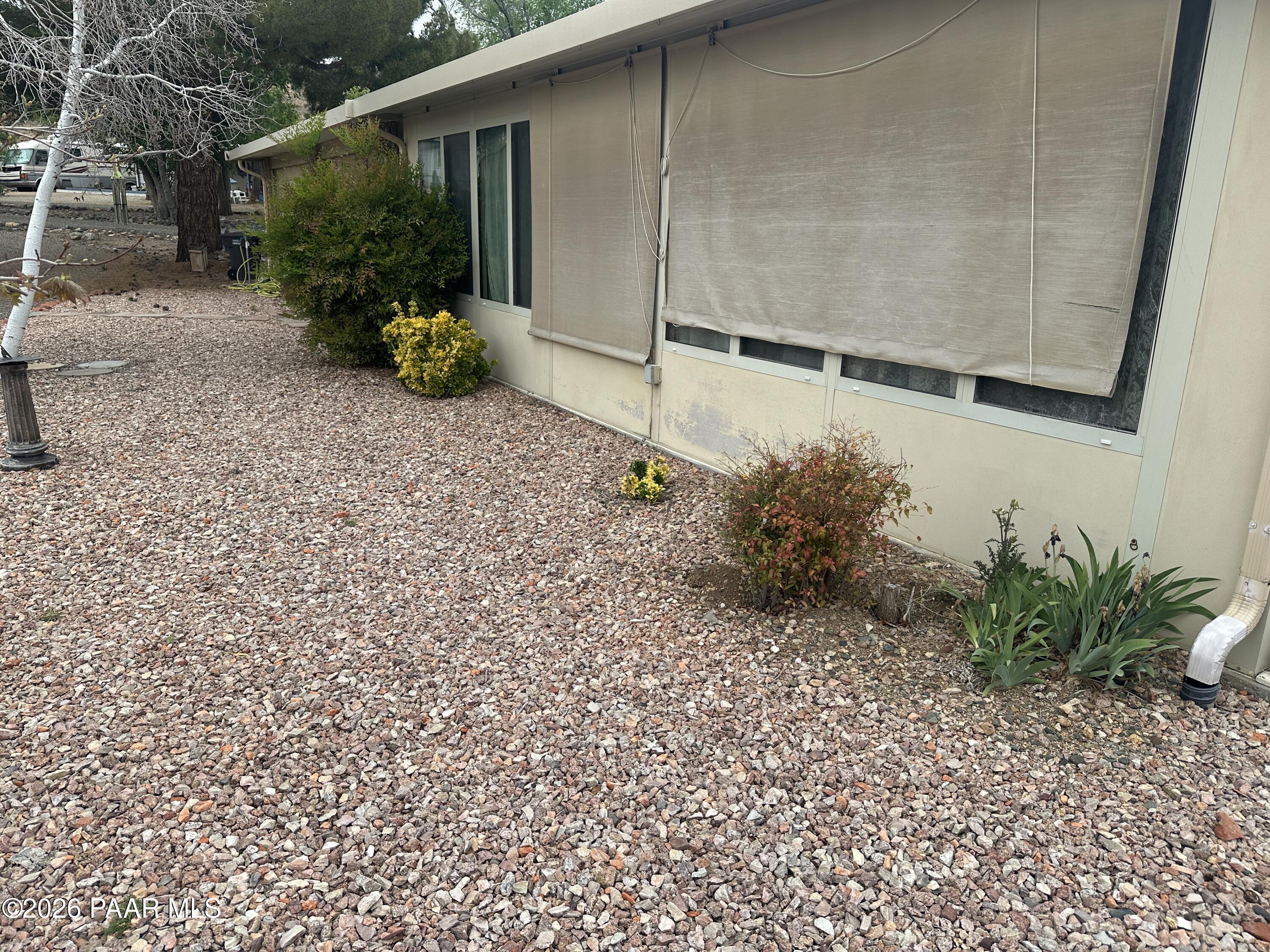 10075 Dapple Grey Trail Dewey, AZ 86327 - Photo 22 of 29 a backyard of a house with plants and outdoor seating