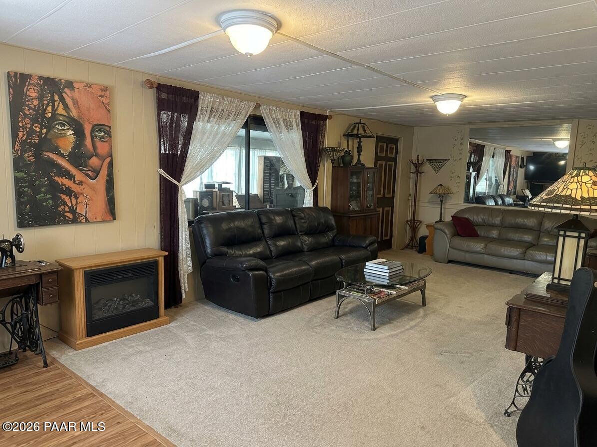 10075 Dapple Grey Trail Dewey, AZ 86327 - Photo 8 of 29 a living room with furniture fireplace and flat screen tv