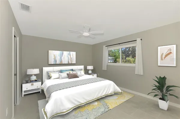 an empty room with windows and fan