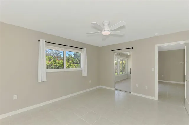 a view of room with window and ceiling fan