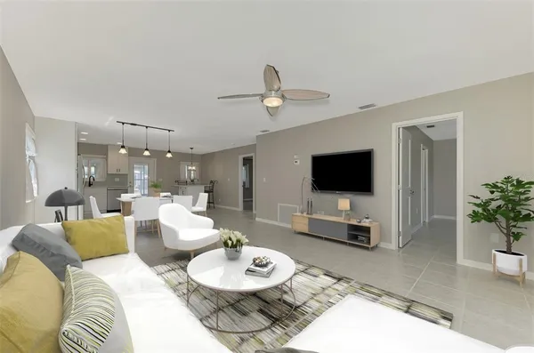 a living room with furniture and a flat screen tv